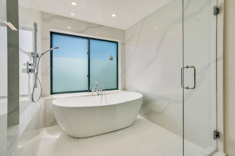 Donley bathroom with freestanding tub and stone finishes